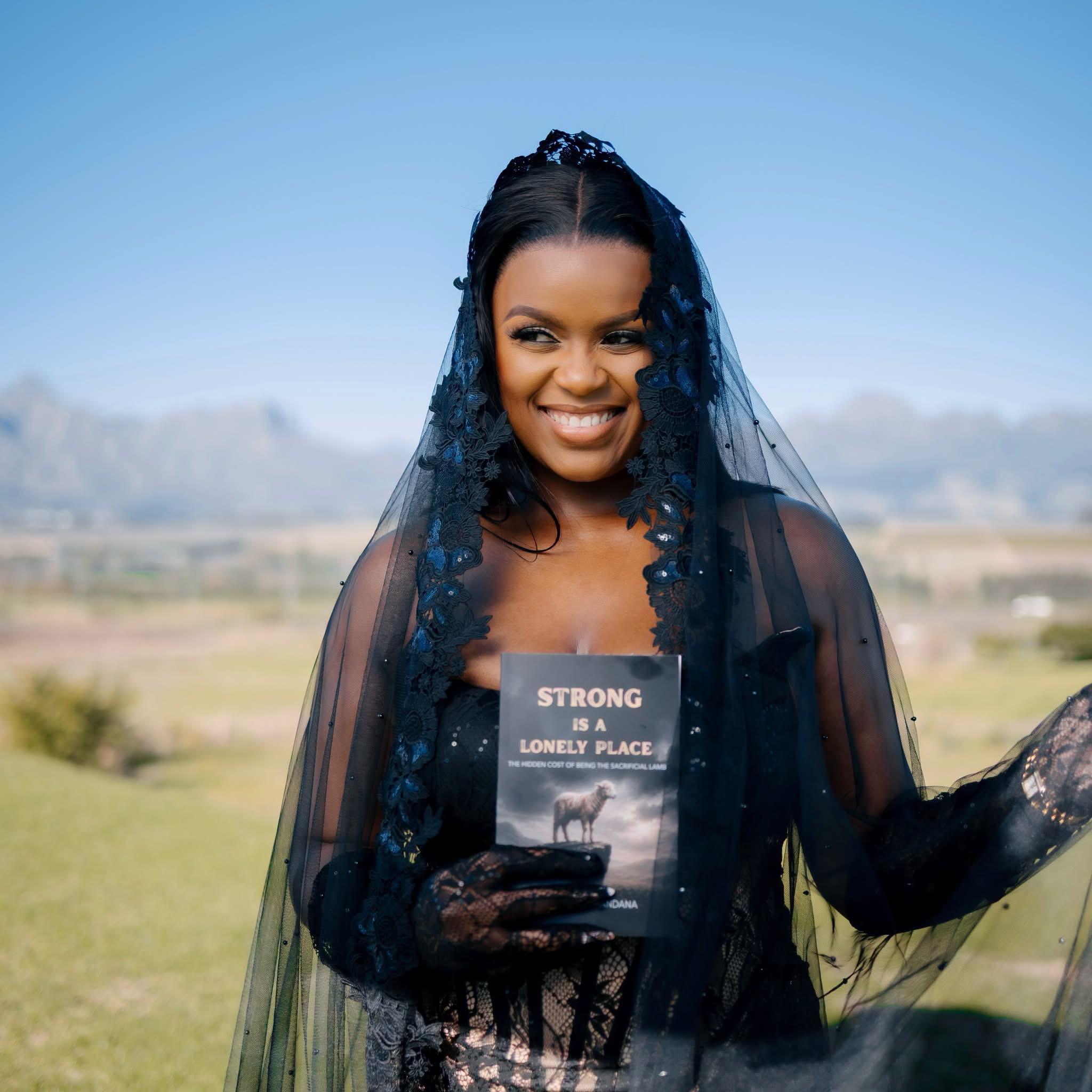 Asanda Hlamandana holding her book